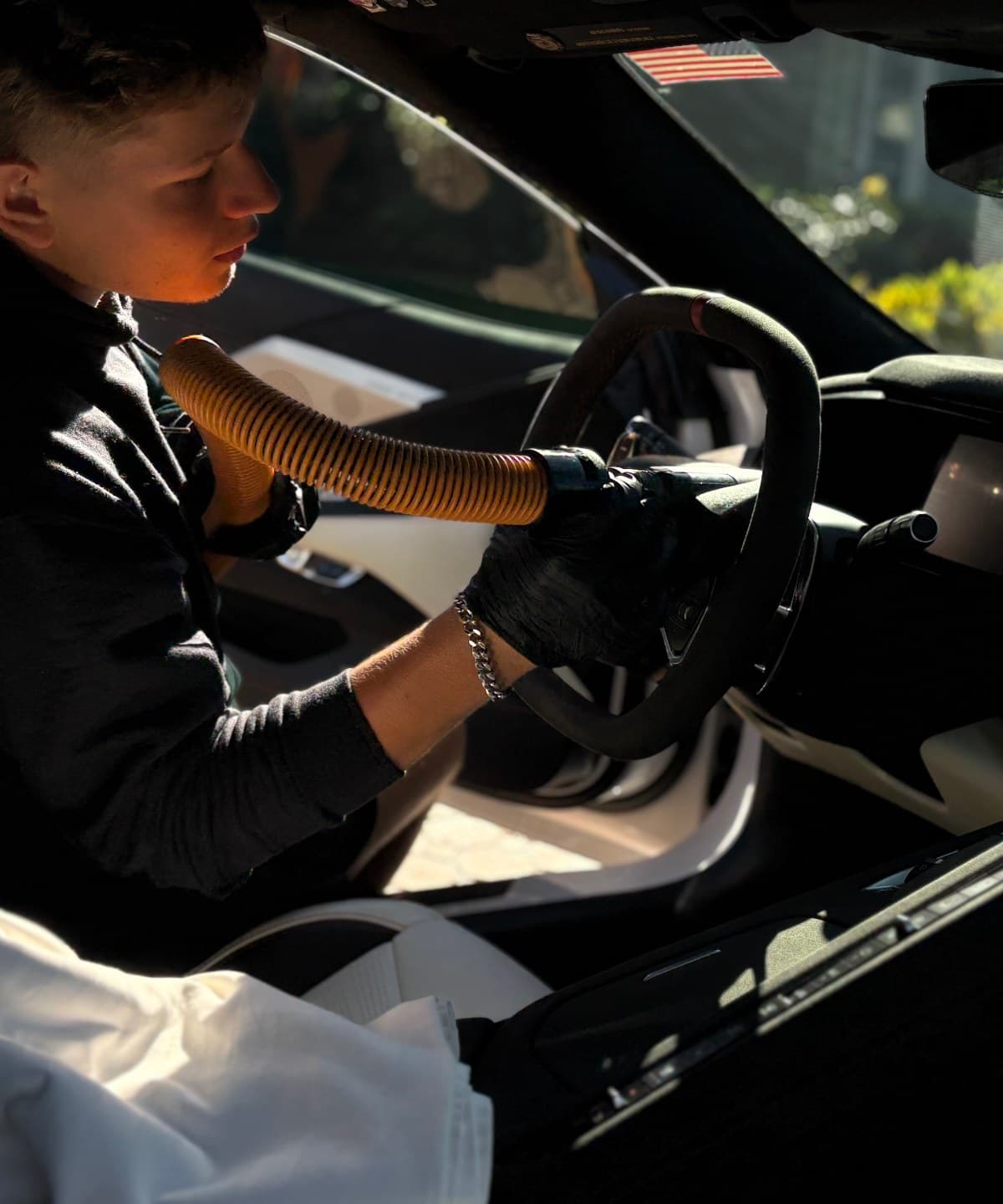 Need For Clean detailer hand-washing a luxury vehicle in a Central Florida driveway